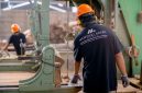 Para operator produksi sedang mengawasi jalannya lini perakitan barang otomatis dengan menerapkan standar keselamatan kerja ketat di salah satu kawasan industri modern.