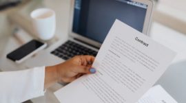 Tampilan resume kerja bersusun rapi di atas meja kantor yang siap dipindai oleh sistem komputer dan diverifikasi oleh manajer perekrutan.