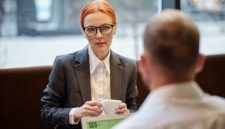 Seorang pelamar sedang menjalani sesi wawancara kerja profesional dengan perekrut di ruang rapat sebuah kantor modern.